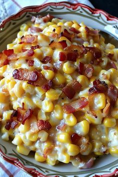 a bowl filled with corn and bacon on top of a table