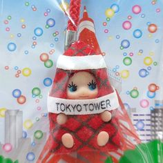 a red and white toy with a sign that says tokyo tower on it's head