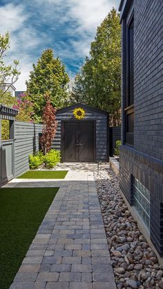 a brick walkway leading to a black building