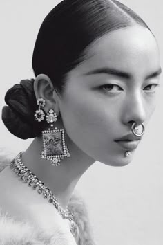 a woman with an unusual nose ring and earrings