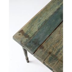 an old wooden table with metal legs on a white background, showing the top part of the table