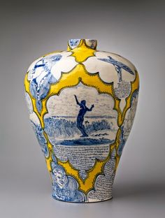 a blue and yellow vase with an image of a man surfing