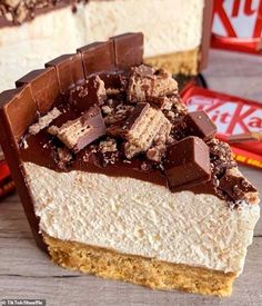 a piece of cheesecake with chocolate and marshmallows on top, next to a candy bar