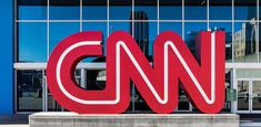 the cnn logo is displayed in front of an office building