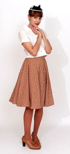 S T R A I G H T T A L K ▲ Circa: 1950s ▲ Tag: Carole Chris of California ▲ Material: Cotton ▲ Condition: Very Good D E T A I L S ▲ Checkered brown circle skirt in a sturdy quilted cotton ▲ Brown, beige and orange checkerboard/diamond pattern ▲ Button and covered zipper to side of waist ▲ Defined waistline with full circle skirt C O N D I T I O N ▲ Very Good S I Z I N G ▲ Would probably best fit a size XS best Waist: 23-24 inch Hips: free Waist to hem (skirt length): 24 inch FOLLOW US ON INSTAGRA Vintage Fitted Cotton Skirt, Vintage Pleated Mini Skirt, Vintage Fitted Pleated Skirt, Vintage Knee-length Brown Skirt, Fitted Vintage Mini Skirt, Vintage Brown Knee-length Skirt, Retro Summer Pencil Skirt, Retro Summer Skirt, Fitted Vintage Skirt For Vintage Fashion