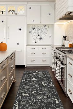 a kitchen with white cabinets and an area rug