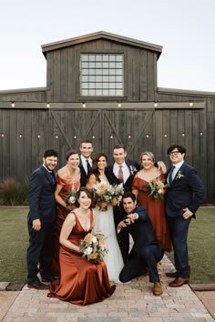 a group of people standing next to each other in front of a wooden building with lights