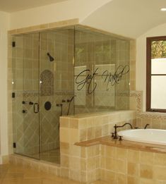 a bathroom with a large tub and walk in shower next to a window on the wall