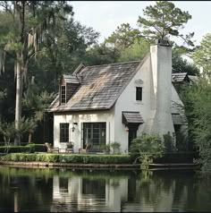 a white house sitting on top of a lake