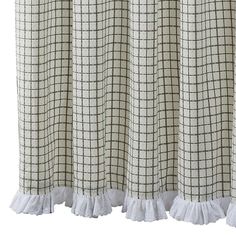 the curtains are lined up with ruffles and plaid fabric on top of them