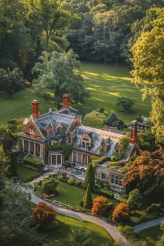 an aerial view of a large home surrounded by trees