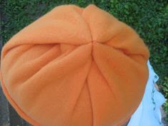 an orange hat sitting on top of a wooden table