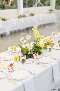 the table is set with flowers and place settings for an elegant wedding breakfast or brunch