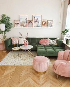 a living room filled with lots of furniture and pink velvet couches on top of hard wood flooring