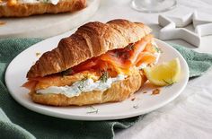 a sandwich with salmon and cream cheese on a croissant