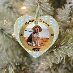 a christmas ornament with a photo of a dog on it hanging from a tree