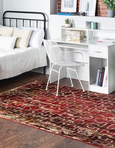 a bedroom area with a bed, desk and chair in it's centerpiece