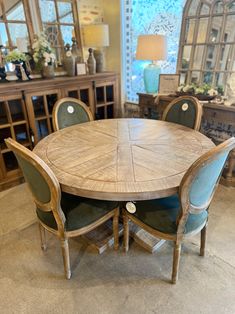 a wooden table with chairs around it in a room filled with furniture and other items