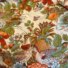 a table cloth with birds and flowers on it