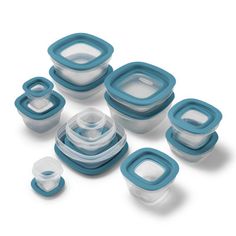 an assortment of food containers and lids on a white surface with blue trimmings