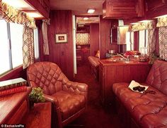 the inside of a train car with leather couches