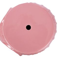 a pink plastic object with a black hole in the center