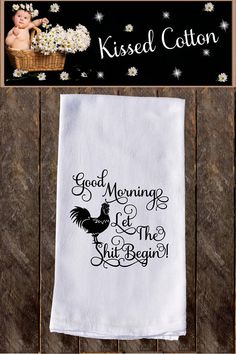 a kitchen towel that says good morning and the fruit bowl is next to it on a wooden