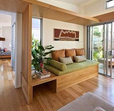 a living room filled with furniture and lots of windows