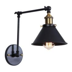 a wall light with a black shade on the side and an antique style lamp attached to it