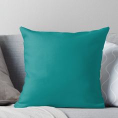 a blue throw pillow sitting on top of a couch