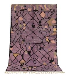 a purple and black rug with fringes on the bottom, in front of a white background