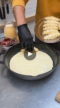 a person in black gloves is making food