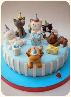 a birthday cake decorated with cats and kittens