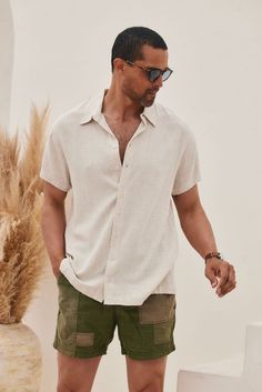 If you're a guy that likes details and neutral tones, then the Vaughn Linen Camp Shirt is perfect for you! Wear it to a festival, on tropical vacation with the boys, or for your casual everyday look. PRODUCT DESCRIPTION AND MATERIALS: - beige linen short sleeve men's top - button up front closure - finished hem - 70% linen, 30% viscose - dry clean only SIZE RECOMMENDATIONS: - True to size Small - length: 29" - chest: 22.25" across -sleeve length: 6.5" Medium - length: 29.5" - chest: 23.25" acros Men’s Linen Button Up, Short Sleeve Linen Shirt Men, Island Men Outfit, Men Linen Outfit Casual, Mens Linen Shorts Outfit, Linen Shirt Outfit Mens, Mens Beach Outfits Casual, Men’s Linen Shirt, Men’s Linen Outfit