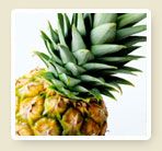 a pineapple with green leaves sitting on top of it