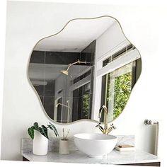 a white sink sitting under a large mirror in a bathroom next to a wall mounted faucet