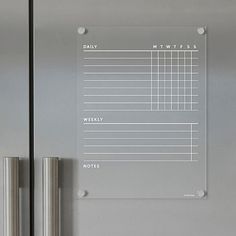 a stainless steel refrigerator with magnets on the front and side panels showing daily tasks