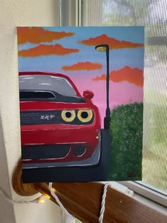 a painting of a red car on a window sill next to a street light