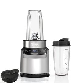 a silver blender sitting next to a black lid