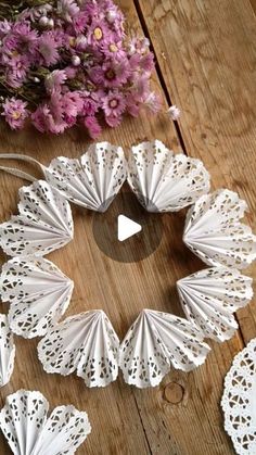 white paper doily on wooden table with flowers