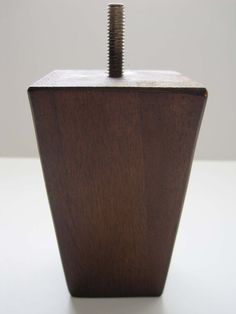 a wooden object with a screw sticking out of it's center and the end of its head