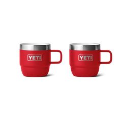 two red yeti mugs sitting next to each other on a white background with the words yeti in silver lettering