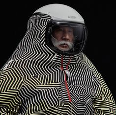 a man wearing a helmet and jacket with an unusual pattern