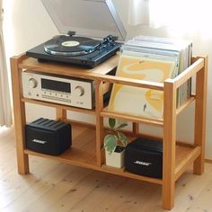 a record player is sitting on top of a shelf