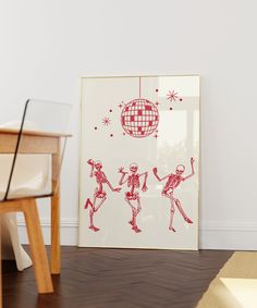 a red and white painting on the wall next to a wooden table with two chairs