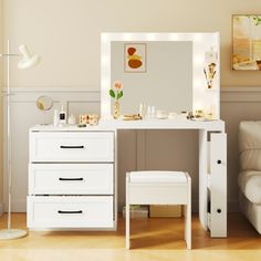 a white dressing table with lights on it