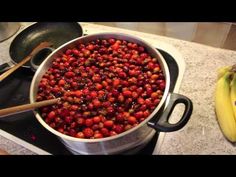 a pan filled with berries sitting on top of a stove