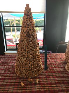 a large stack of wine corks sitting on top of a red and white table cloth