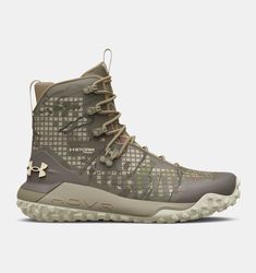 the under armour boots are designed with an all - terrain pattern and rubber soles