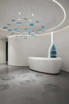 a large white room with a circular ceiling and blue decorations on the wall above it